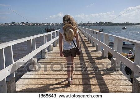 Stock Image - Woman On Boardwalk, Lamu Archipelago, Kenya, Africa. Fotosearch