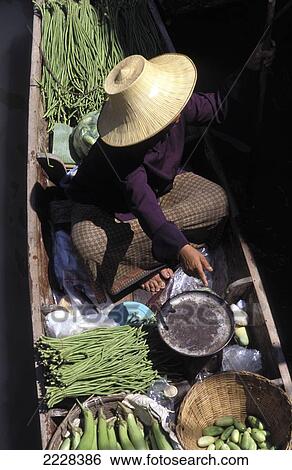 Stock Photograph - Woman On Boat In The Floating Market, Bangkok, Thailand.. Fotosearch