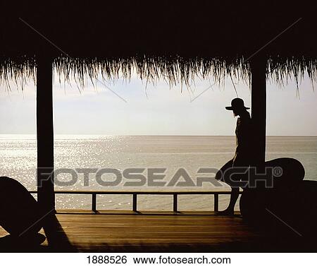 Stock Photograph - Woman On Porch Overlooking Ocean. Fotosearch