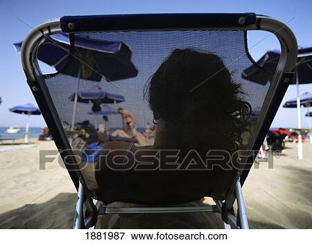 Woman On Sun Bed On Faliraki Beach, Rear View View Large Photo Image Stock Photo - Woman On Sun Bed On Faliraki Beach, Rear View. Fotosearch