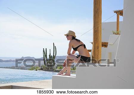 Stock Image - Woman On Terrace, Cabo San Lucas, Mexico. Fotosearch