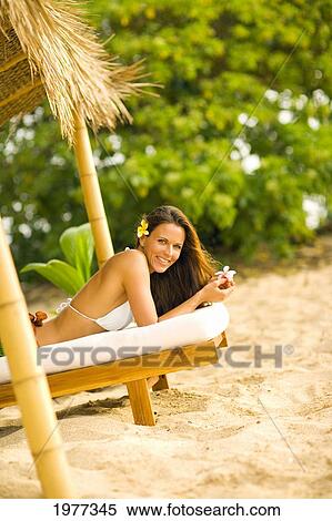Woman On Wooden Lounge Chair Under Thatched Hut. View Large Photo Image Stock Photography - Woman On Wooden Lounge Chair Under Thatched Hut.. Fotosearch