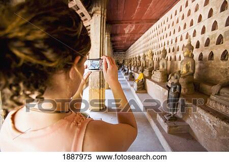 Woman Photographing In Cloister Containing Over 2000 Silver And Ceramic Buddhas In Small Niches. View Large Photo Image Stock Photography - Woman Photographing In Cloister Containing Over 2000 Silver And Ceramic Buddhas In Small Niches.. Fotosearch