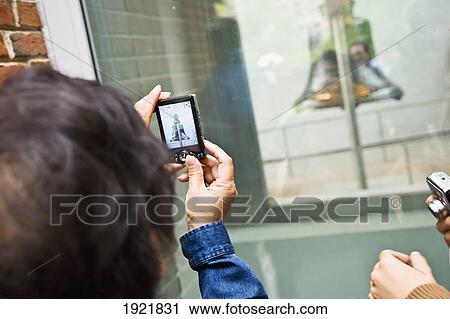 Stock Image - Woman Photographing Liberty Bell. Fotosearch