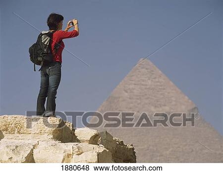 Stock Photo - Woman Photographing Pyramid Of Chephren. Fotosearch