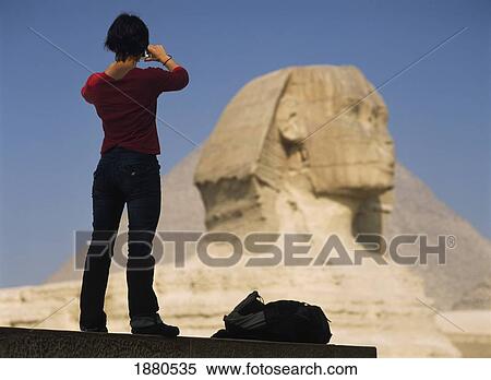 Stock Photography - Woman Photographing Sphinx And Great Pyramid Of Cheops. Fotosearch