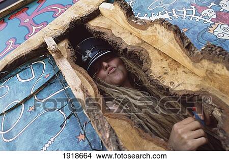 Picture - Woman Posing In Wooden Structure. Fotosearch