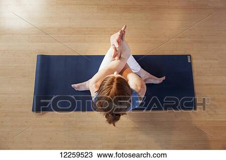 Stock Image - Woman practices yoga at indoor studio, Homer, Alaska. Fotosearch