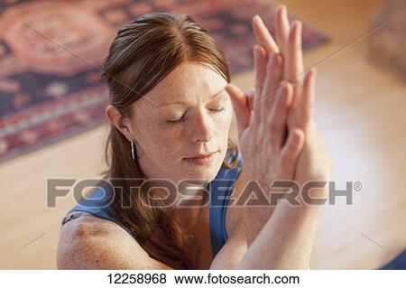 Woman practices yoga at indoor studio View Large Photo Image Stock Photo - Woman practices yoga at indoor studio. Fotosearch