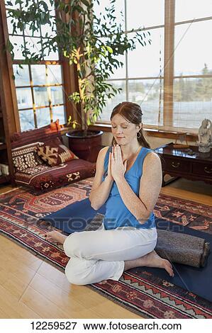 Stock Photo - Woman practices yoga at indoor studio, Homer, Alaska. Fotosearch