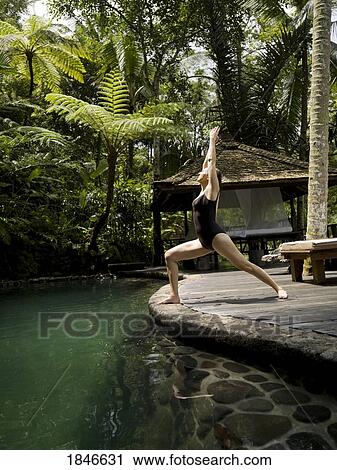 Woman Practicing Yoga In Holiday Resort; Bali, Indonesia View Large Photo Image Stock Image - Woman Practicing Yoga In Holiday Resort; Bali, Indonesia. Fotosearch
