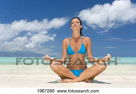Woman Practicing Yoga On Tropical Beach, Lotus Position. View Large Photo Image Stock Photo - Woman Practicing Yoga On Tropical Beach, Lotus Position.. Fotosearch