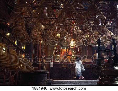 Stock Photograph - Woman Praying At Shrine In Temple, Hong Kong. Fotosearch