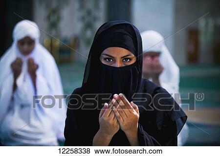Woman praying in a mosque; Bandar Seri Begawan, Brunei View Large Photo Image Stock Photo - Woman praying in a mosque; Bandar Seri Begawan, Brunei. Fotosearch