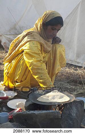 Woman Preparing Breakfast Outside A Relief Camp Tent After The 8 October 2005 Earthquake, Bagh, Azad Kashmir, Pakistan View Large Photo Image Stock Image - Woman Preparing Breakfast Outside A Relief Camp Tent After The 8 October 2005 Earthquake, Bagh, Azad Kashmir, Pakistan. Fotosearch