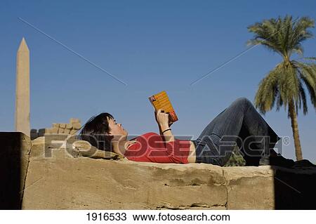 Stock Image - Woman Reading Guidebook To Egypt. Fotosearch
