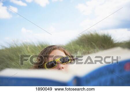 Stock Photo - Woman Reading On Beach. Fotosearch