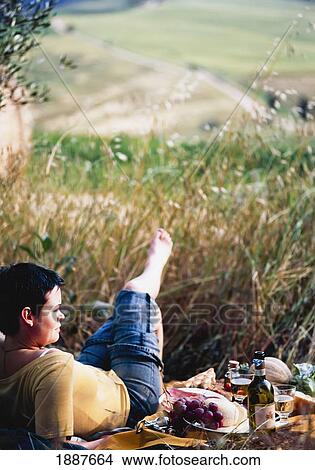Woman Relaxing Beside Picnic In Field View Large Photo Image Picture - Woman Relaxing Beside Picnic In Field. Fotosearch