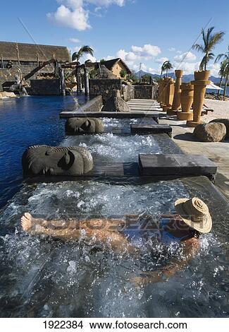 Picture - Woman Relaxing In Swimming Pool. Fotosearch
