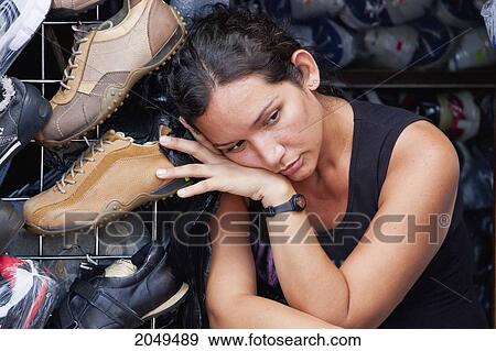 Stock Photo - Woman Resting In A Shoe Store, Guayaquil, Guayas, Ecuador. Fotosearch