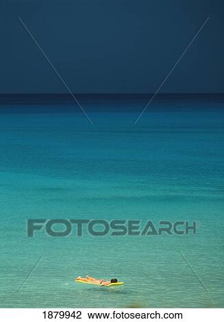 Stock Image - Woman Resting On Lilo. Fotosearch