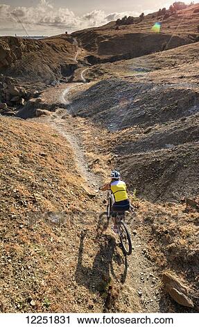 Woman riding a mountain bike on a rugged trail; Tarifa, Cadiz, Andalusia, Spain View Large Photo Image Stock Image - Woman riding a mountain bike on a rugged trail; Tarifa, Cadiz, Andalusia, Spain. Fotosearch