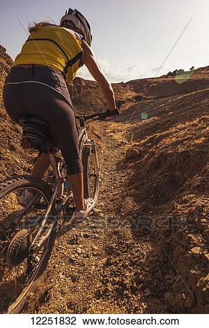 Woman riding a mountain bike on a rugged trail; Tarifa, Cadiz, Andalusia, Spain View Large Photo Image Stock Image - Woman riding a mountain bike on a rugged trail; Tarifa, Cadiz, Andalusia, Spain. Fotosearch