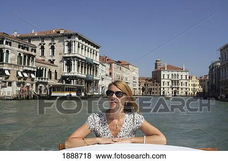 Stock Photo - Woman Riding On A Water Taxi In Venice, Grand Canal. Fotosearch