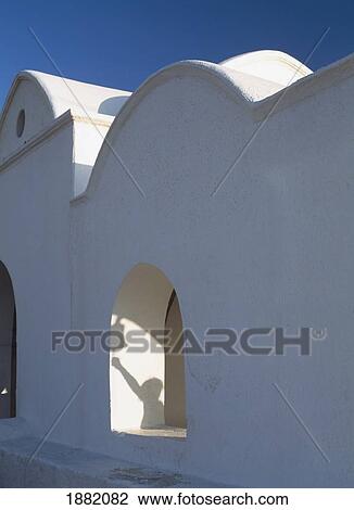 Stock Image - Woman Rining Bell To Plimiri Church. Fotosearch