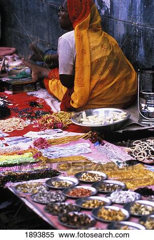 Stock Photography - Woman Selling Artificial Jewelry And Trinkets During Fair, Rear View. Fotosearch