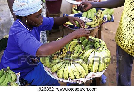 Stock Image - Woman Selling Bananas; Gambia. Fotosearch