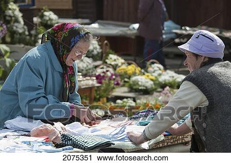 Stock Image - Woman Selling Clothes In Trakai, Lithuania. Fotosearch