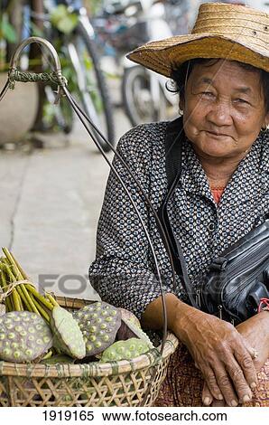 Stock Photography - Woman Selling Lotus Seed Heads. Fotosearch