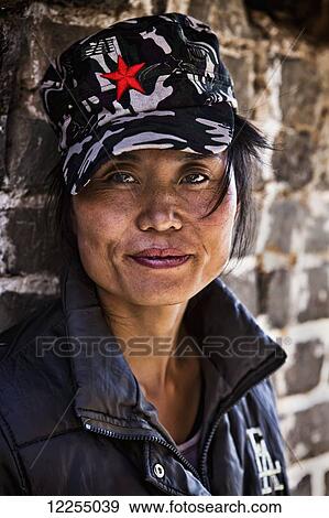 Stock Photo - Woman selling trinkets along the Great Wall of China; Jinshanling, China. Fotosearch