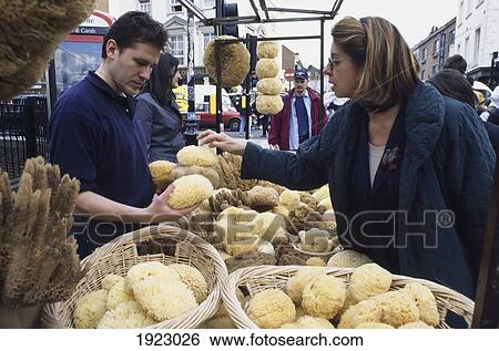 Stock Photograph - Woman Shopping For A Natural Sponge. Fotosearch