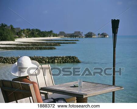Woman Sitting At Table On Beach View Large Photo Image Stock Image - Woman Sitting At Table On Beach. Fotosearch