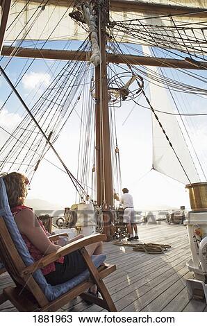 Woman Sitting In Chair Watch Crew Member Work The Sails View Large Photo Image Stock Image - Woman Sitting In Chair Watch Crew Member Work The Sails. Fotosearch