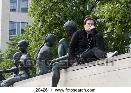 Woman Sitting On A Balustrade By The Spree River, Berlin, Germany View Large Photo Image Stock Photo - Woman Sitting On A Balustrade By The Spree River, Berlin, Germany. Fotosearch