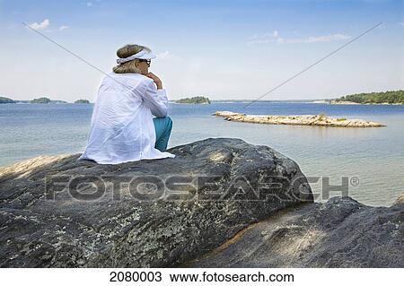 Woman Sitting On A Rocky Shoreline Overlooking Georgian Bay At Killbear Provincial Park; Ontario, Canada View Large Photo Image Stock Image - Woman Sitting On A Rocky Shoreline Overlooking Georgian Bay At Killbear Provincial Park; Ontario, Canada. Fotosearch