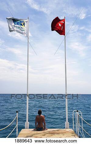 Woman Sitting On End Of Pier By Sea View Large Photo Image Stock Image - Woman Sitting On End Of Pier By Sea. Fotosearch