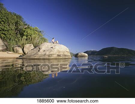 Woman Sitting On Rock On The Island Of Domwe View Large Photo Image Stock Image - Woman Sitting On Rock On The Island Of Domwe. Fotosearch