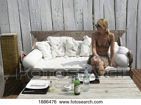 Woman Sitting On Wicker Sofa On Deck View Large Photo Image Stock Photograph - Woman Sitting On Wicker Sofa On Deck. Fotosearch