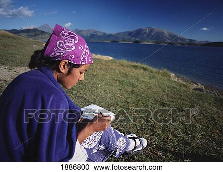 Stock Image - Woman Sketching Hills Of Gran Sasso National Park Beside Lago Di Campotosto. Fotosearch