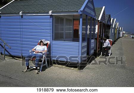 Woman Sleeping With Newspaper On Head Outside Beach Hut; Southwold, Norfolk, England View Large Photo Image Stock Photo - Woman Sleeping With Newspaper On Head Outside Beach Hut; Southwold, Norfolk, England. Fotosearch