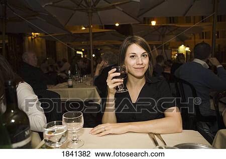 Stock Image - Woman Smiling With Glass Of Wine, Outdoors; Roma Italy. Fotosearch