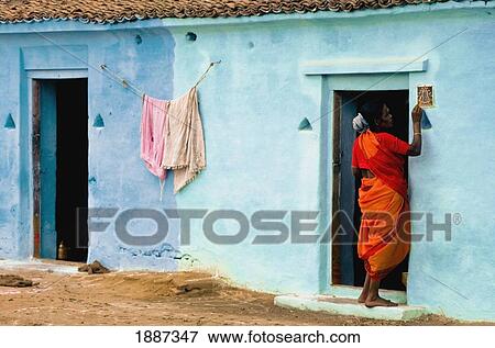 Stock Photo - Woman Standing At House Doors. Fotosearch