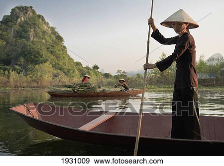 Woman Standing In Rowing Boat, Wearing Traditional Dress View Large Photo Image Stock Photo - Woman Standing In Rowing Boat, Wearing Traditional Dress. Fotosearch