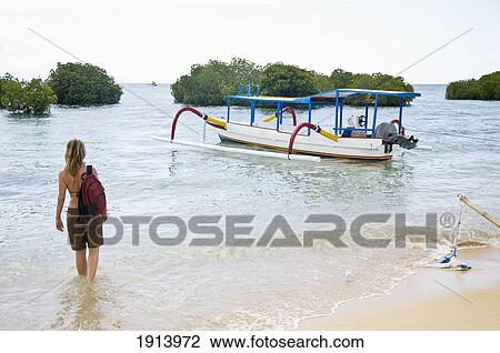 Stock Image - Woman Standing In Sea. Fotosearch