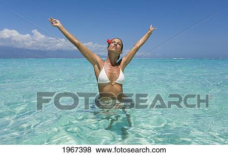 Woman Standing In Tropical Ocean Water. View Large Photo Image Stock Photo - Woman Standing In Tropical Ocean Water.. Fotosearch