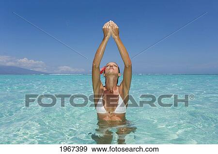 Stock Photo - Woman Standing In Tropical Ocean Water.. Fotosearch